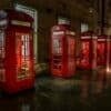 red telephone booth on brown brick floor