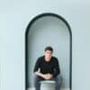 Barefoot Man Siting on Chair in Niche