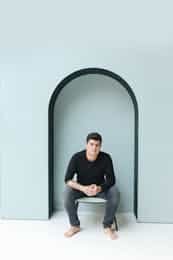 Barefoot Man Siting on Chair in Niche