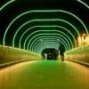 Man Walking on the Bridge with Neon Lights