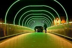 Man Walking on the Bridge with Neon Lights