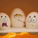 2 white and black ceramic egg figurines