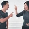 man in gray crew neck long sleeve shirt standing beside woman in black crew neck shirt