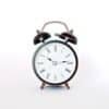 round black and white analog alarm clock